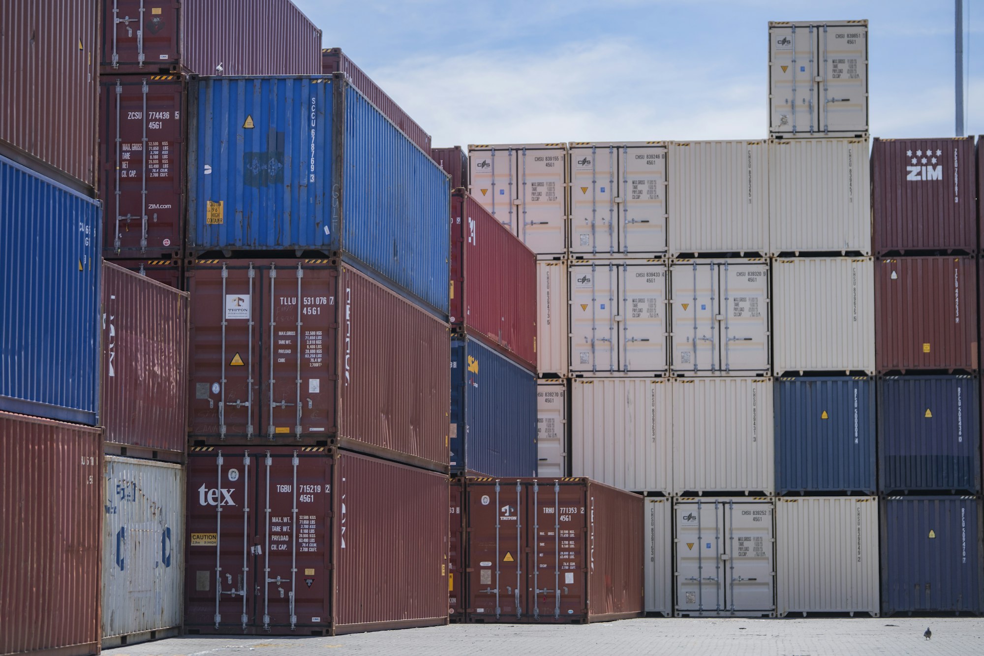 Colorful shipping containers stacked at a working port